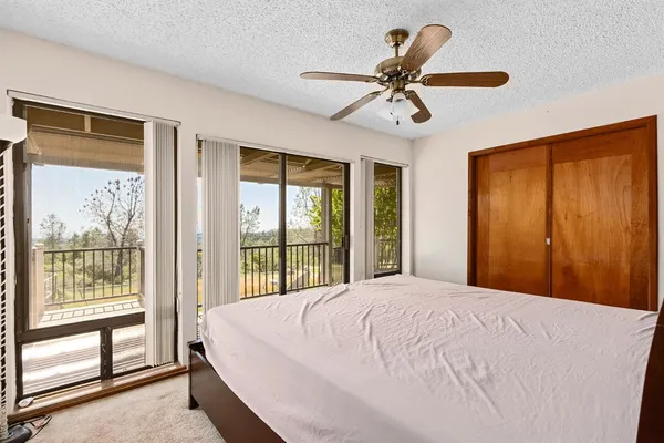 a bed room with a bed and a chair