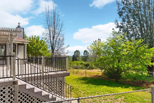 a view of yard with swimming pool and green space