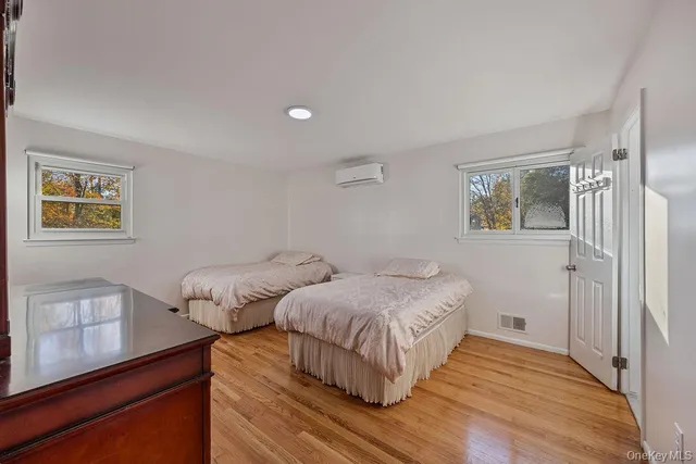 a bedroom with two beds and painting on the wall