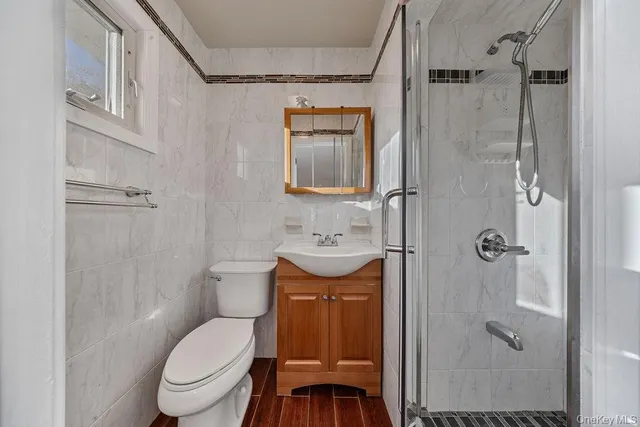 a bathroom with a toilet sink shower and mirror
