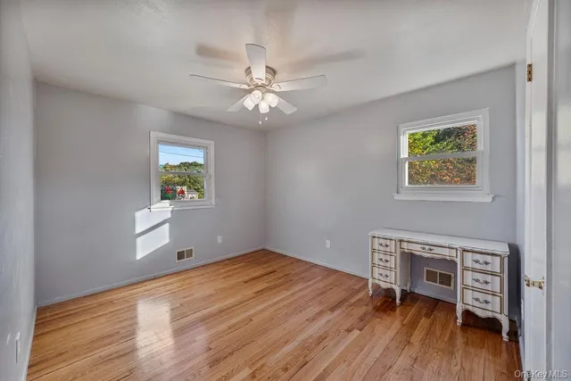 wooden floor in an empty room with a window