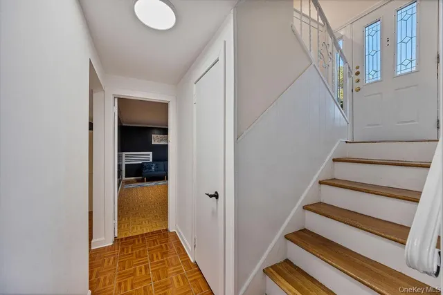 a view of entryway and hall with wooden floor