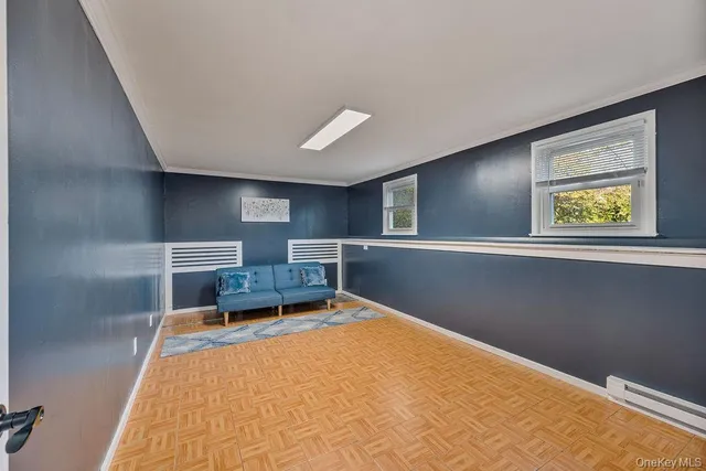 a bed room with a bed and painting on the wall