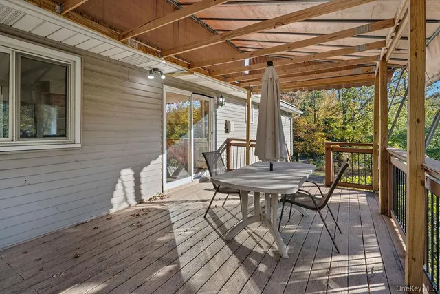a view of a patio with table and chairs and wooden floor