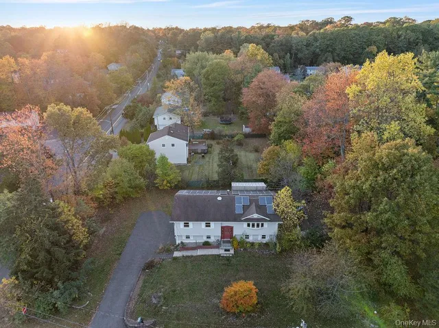 an aerial view of a house with a yard