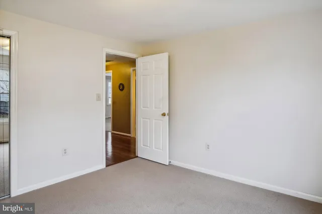 an empty room with closet and a bathroom