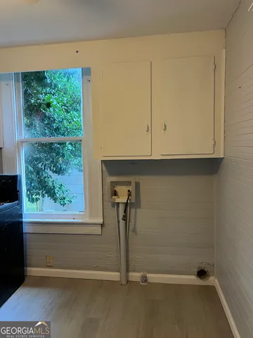 a view of storage and utility room with a window