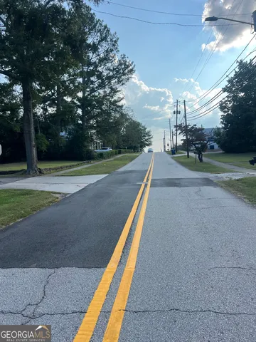a view of a park with large trees
