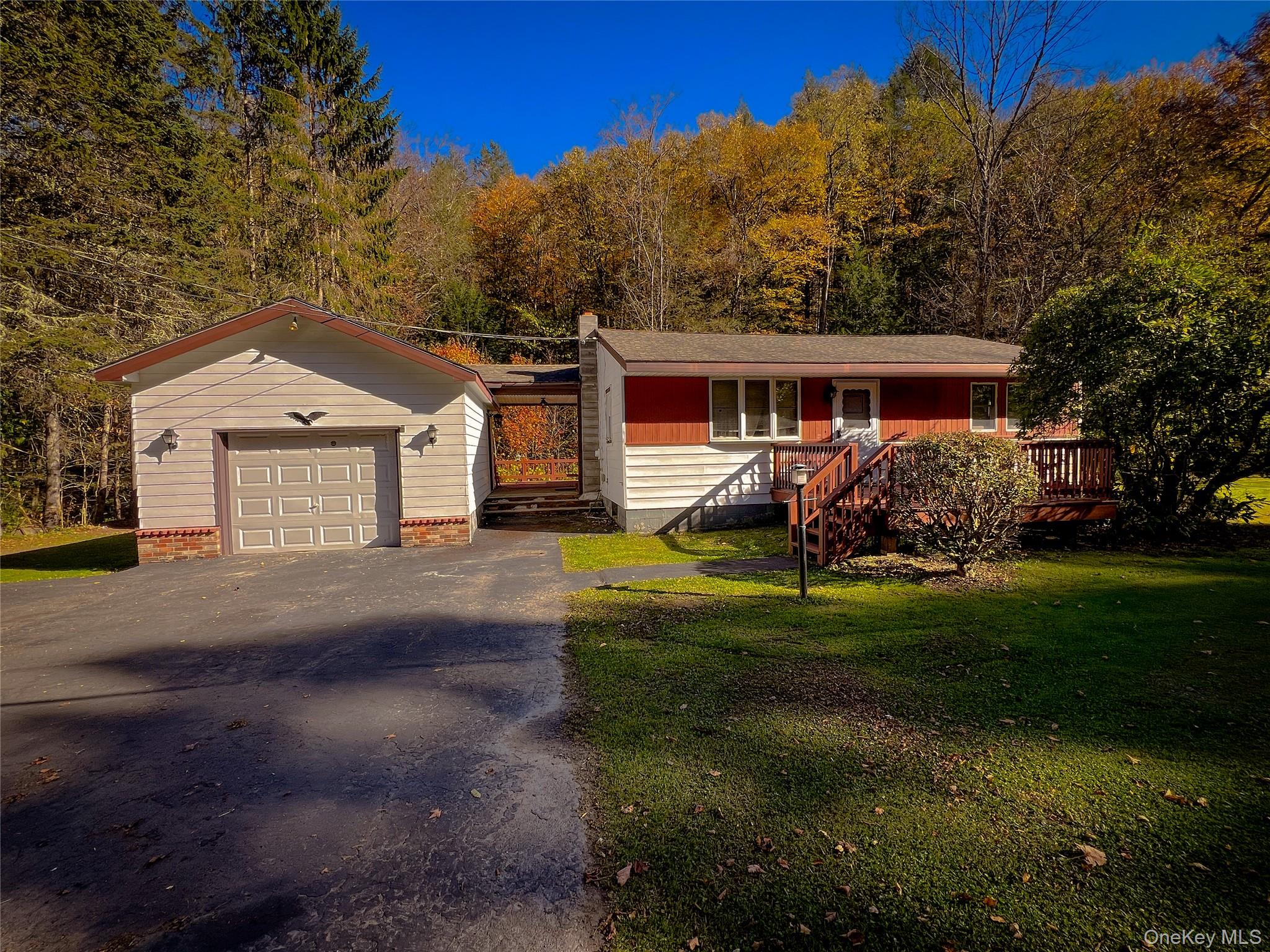 a front view of house with yard and green space