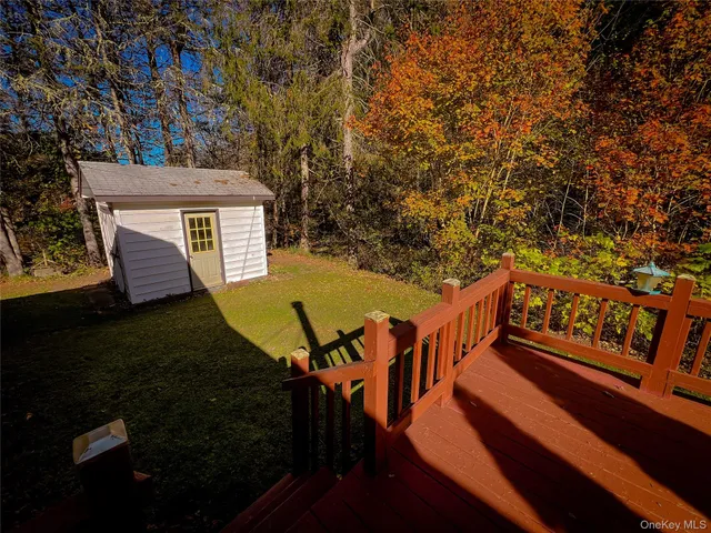 a view of an chairs and deck in the backyard