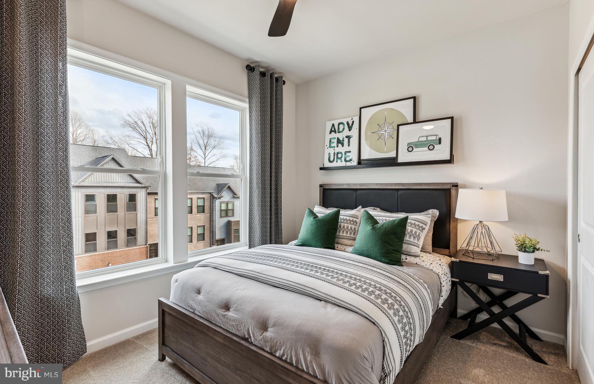 42609 Houdini Rst Terrace Leesburg, VA 20176 - Photo 8 of 27 a bedroom with a bed paintings on the wall and a window