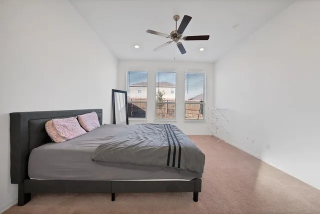 a bed sitting in a bedroom next to a window
