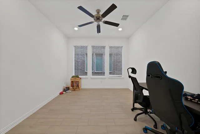 a room with gym equipment and windows