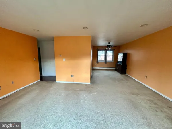 a view of a livingroom with a yellow & white wall