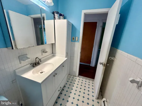 a bathroom with a sink a mirror and shower