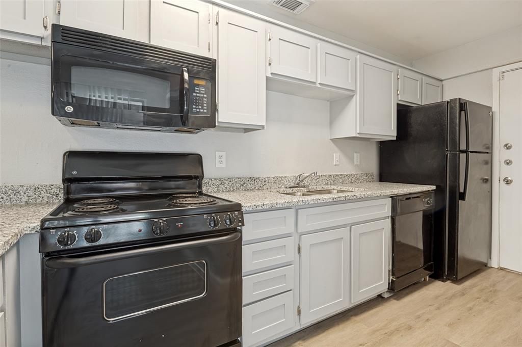 622 West Union Bower Road Irving, TX 75061 - Photo 4 of 13 Kitchen featuring light gray cabinetry, speckled countertops, a black electric range, a black over-the-range microwave, and a black refrigerator