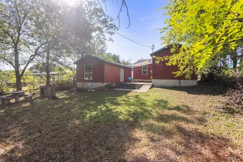 a backyard of a house with large trees and a lots of trees