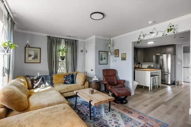 a living room with furniture and wooden floor