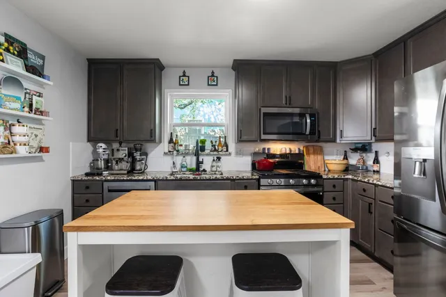 a kitchen with a stove a sink and a microwave