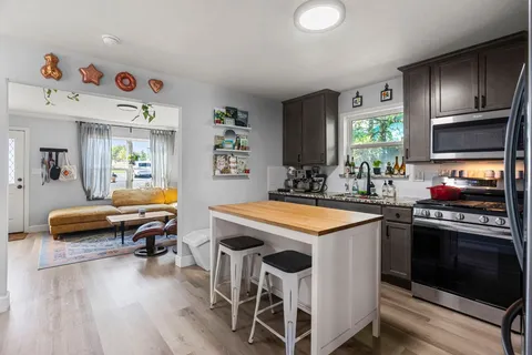 a kitchen with a sink stove and cabinets