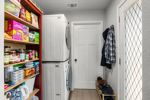 a view of walk in closet with clothes and shoes