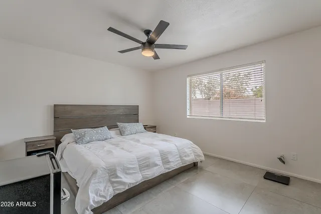a bedroom with a bed and window