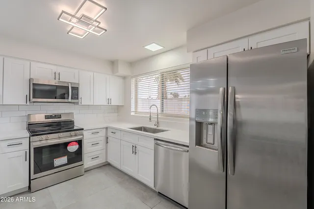 a kitchen with a refrigerator and a sink
