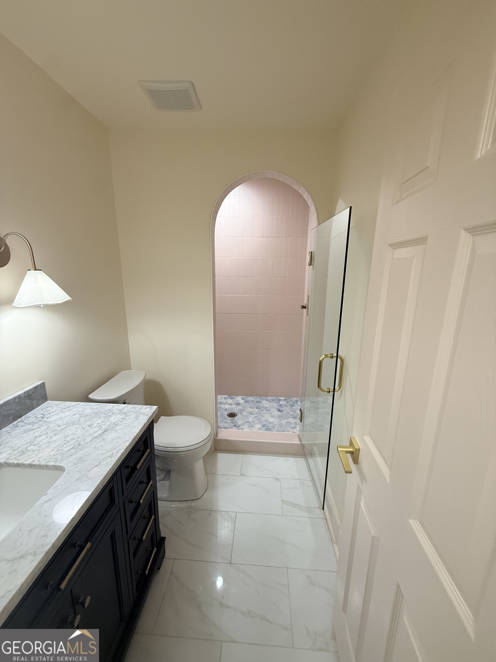 1021 Twins Road Greensboro, GA 30642 - Photo 14 of 32 a bathroom with a granite countertop sink a toilet and a mirror