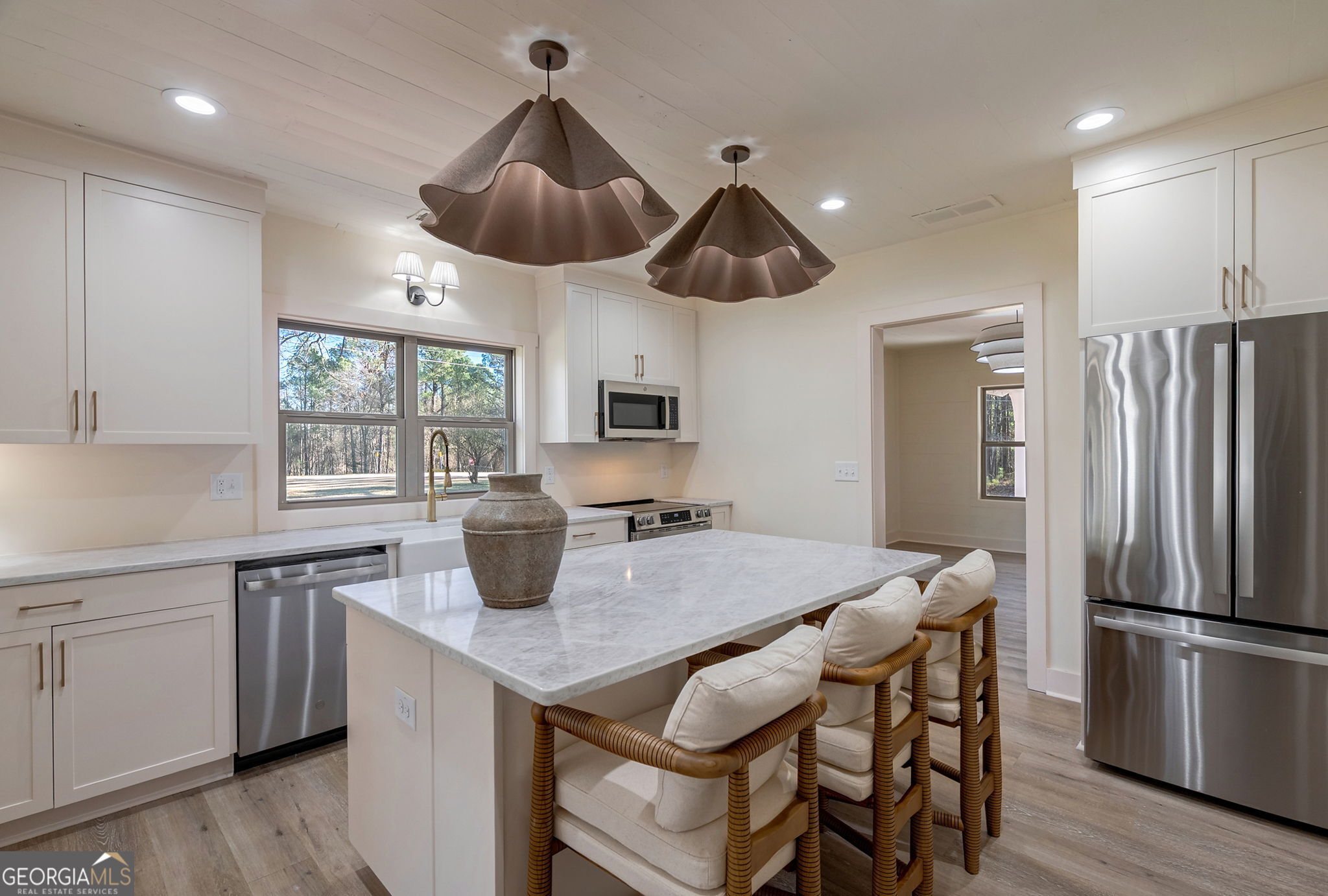 1021 Twins Road Greensboro, GA 30642 - Photo 5 of 32 a kitchen with stainless steel appliances a dining table and chairs