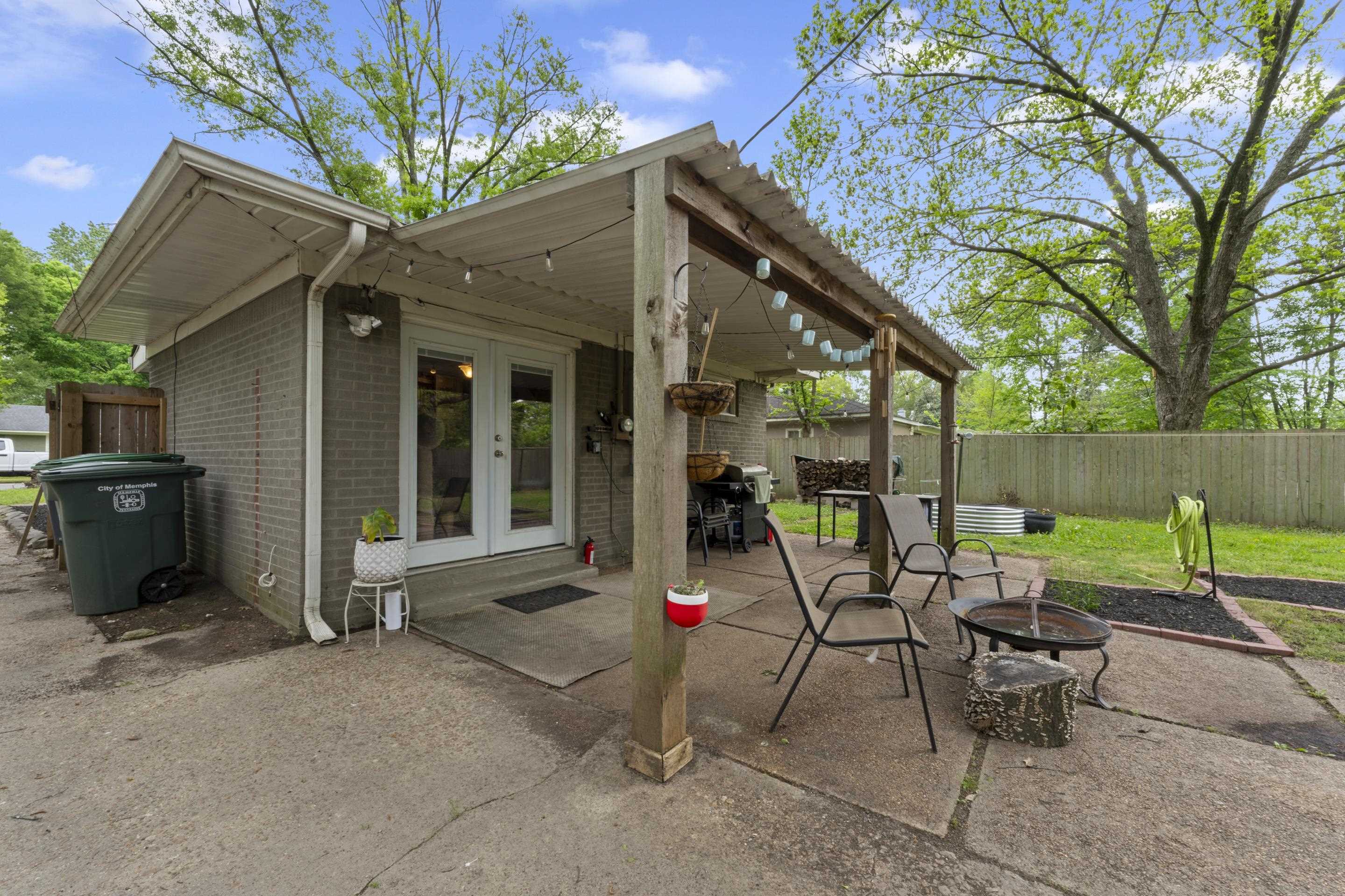 1343 Dearing Road Memphis, TN 38117 - Photo 18 of 19 Concrete patio featuring a covered outdoor area with a corrugated metal roof