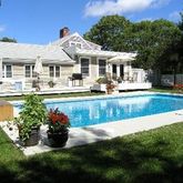 a front view of a house with swimming pool having outdoor seating