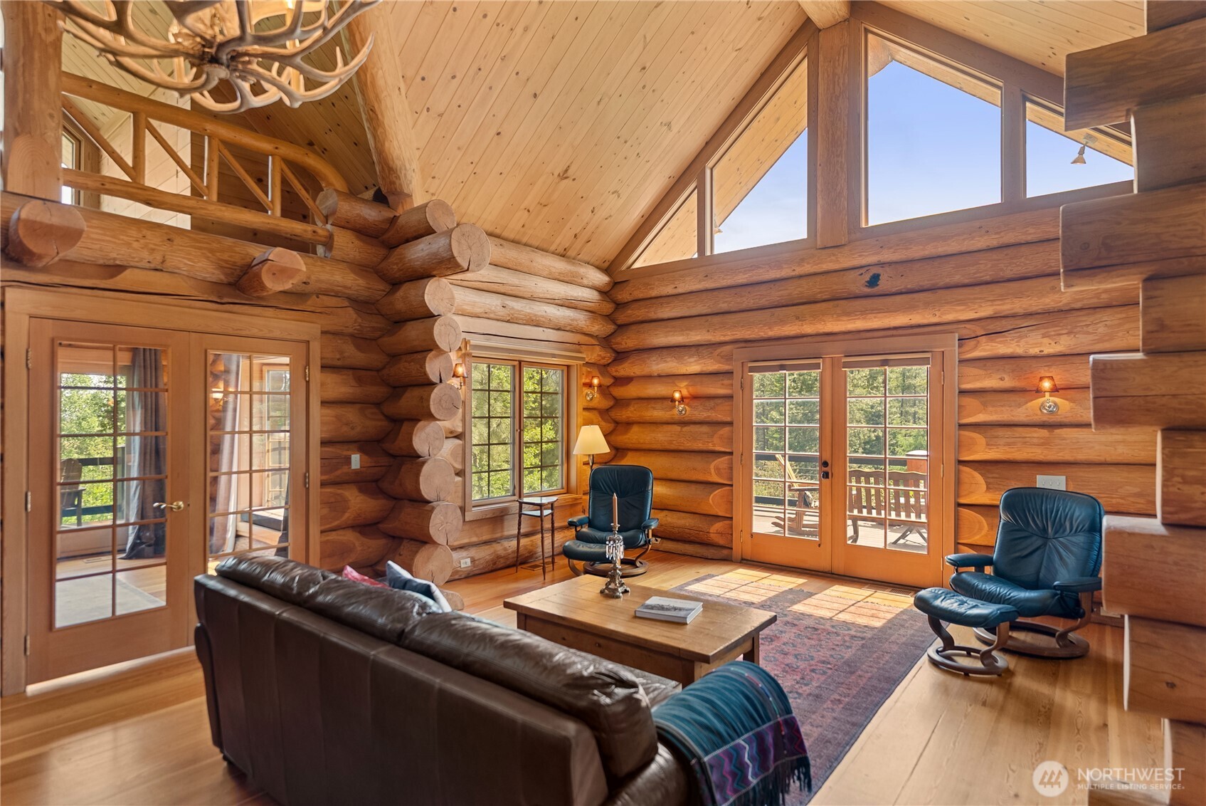 116 Lost River Road Mazama, WA 98833 - Photo 15 of 40 a living room with furniture and floor to ceiling windows