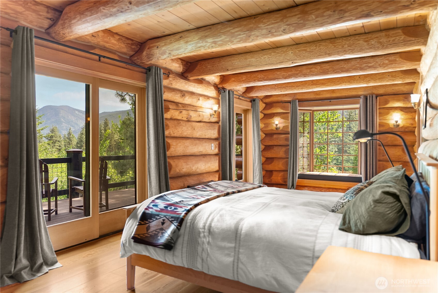 116 Lost River Road Mazama, WA 98833 - Photo 18 of 40 a bedroom with a bed and a large window with outer view
