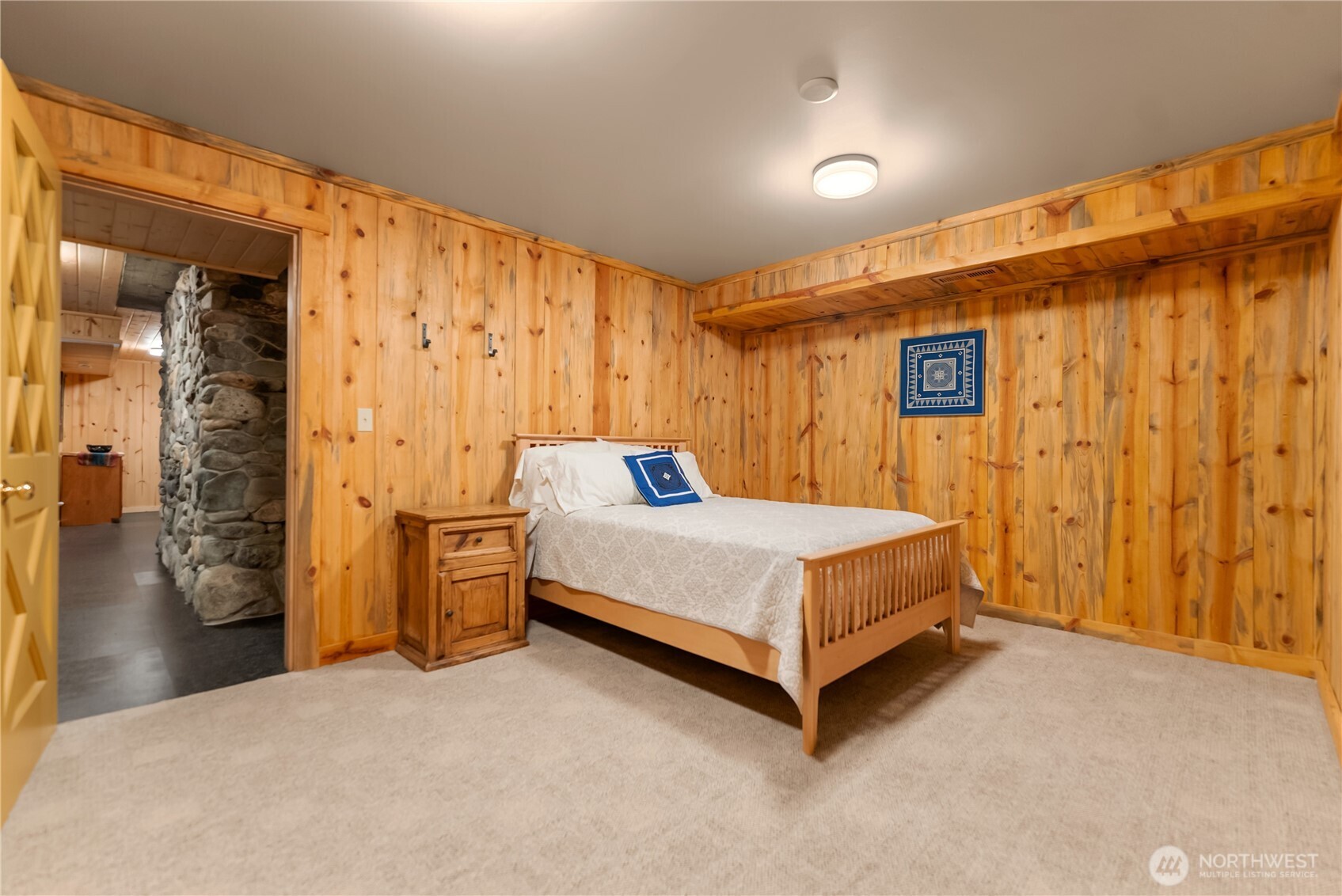116 Lost River Road Mazama, WA 98833 - Photo 29 of 40 a bedroom with a bed and wooden floor