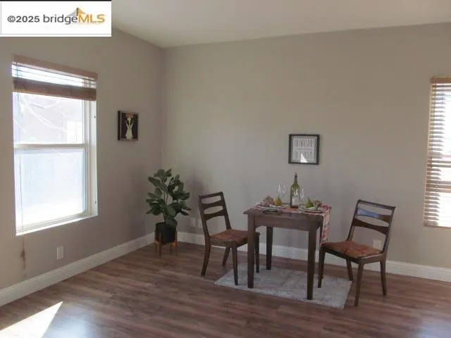 a dining room with furniture and wooden floor