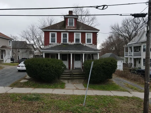 a front view of a house with a garden