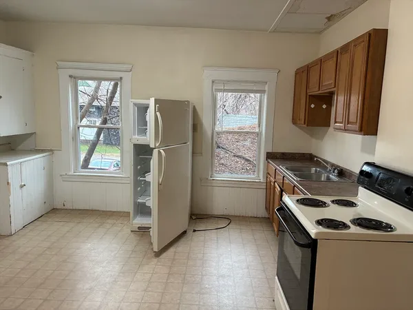 a kitchen with a stove a refrigerator and a sink