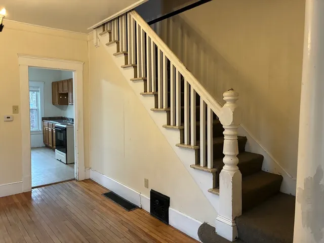 a view of entryway and hall with wooden floor