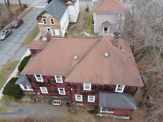 an aerial view of a house with a yard