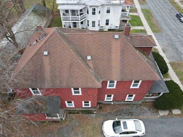 an aerial view of a house with a yard