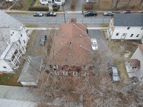 an aerial view of residential houses with outdoor space
