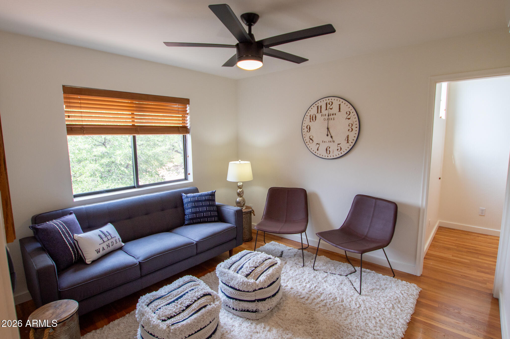 5120 Juniper Loop Pine, AZ 85544 - Photo 19 of 54 a living room with furniture a clock and a window