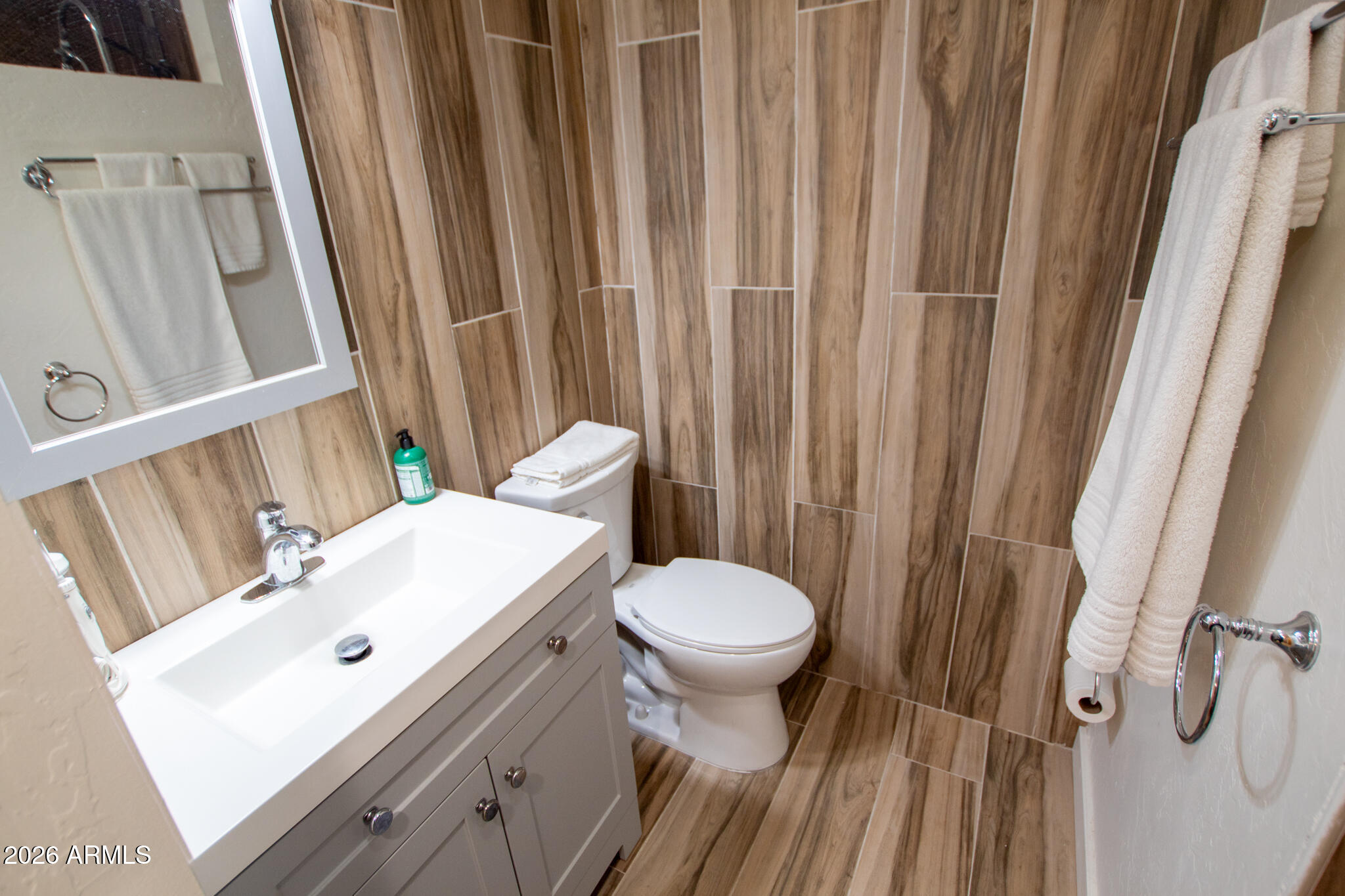 5120 Juniper Loop Pine, AZ 85544 - Photo 29 of 54 a bathroom with a sink a toilet a mirror and shower curtain
