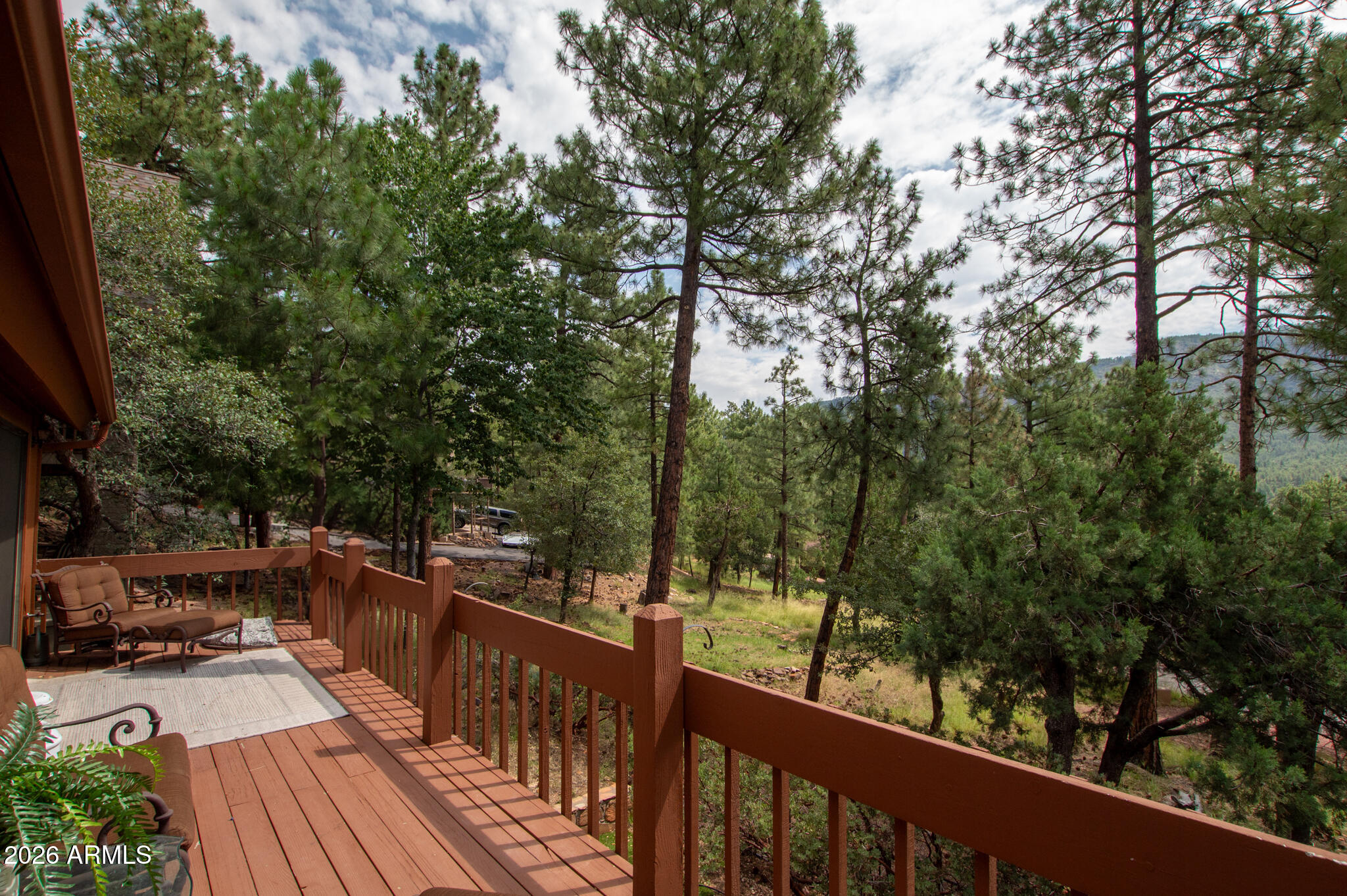 5120 Juniper Loop Pine, AZ 85544 - Photo 44 of 54 a view of a balcony with wooden floor and trees