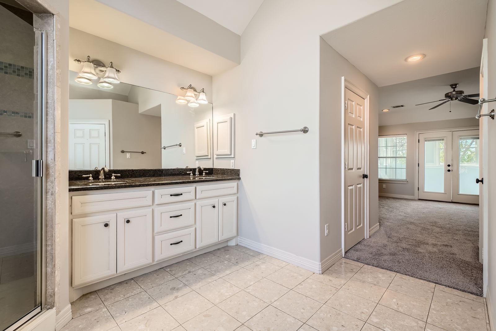 806 East 29th Street Houston, TX 77009 - Photo 17 of 30 The spacious primary bathroom with a double vanity featuring granite countertops and white cabinetry. .