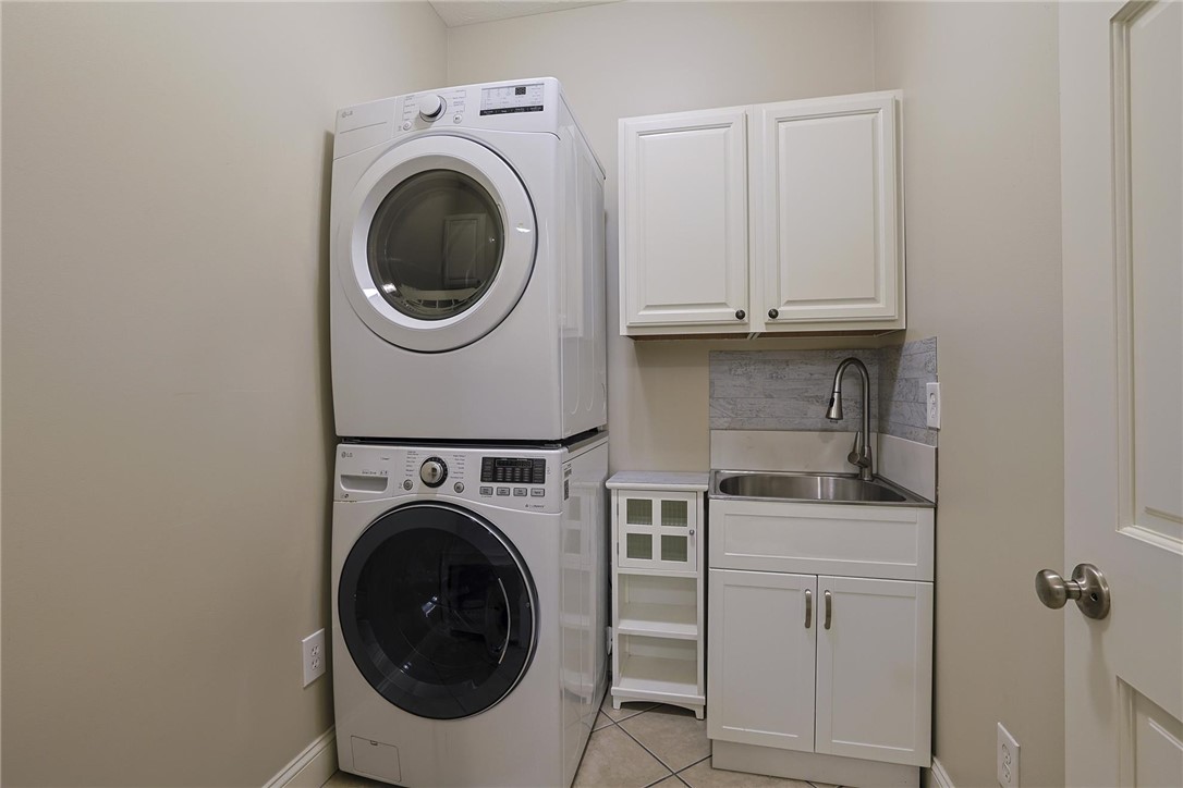 3681 Wilmington Road Lebanon, OH 45036 - Photo 55 of 87 Functional laundry space featuring stacked appliances and integrated sink for efficiency.