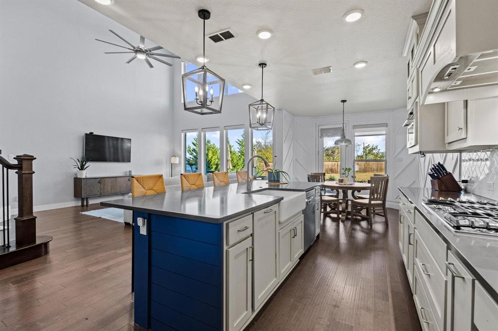 13798 Fernando Road Frisco, TX 75035 - Photo 11 of 39 a kitchen with stainless steel appliances granite countertop a stove and cabinets