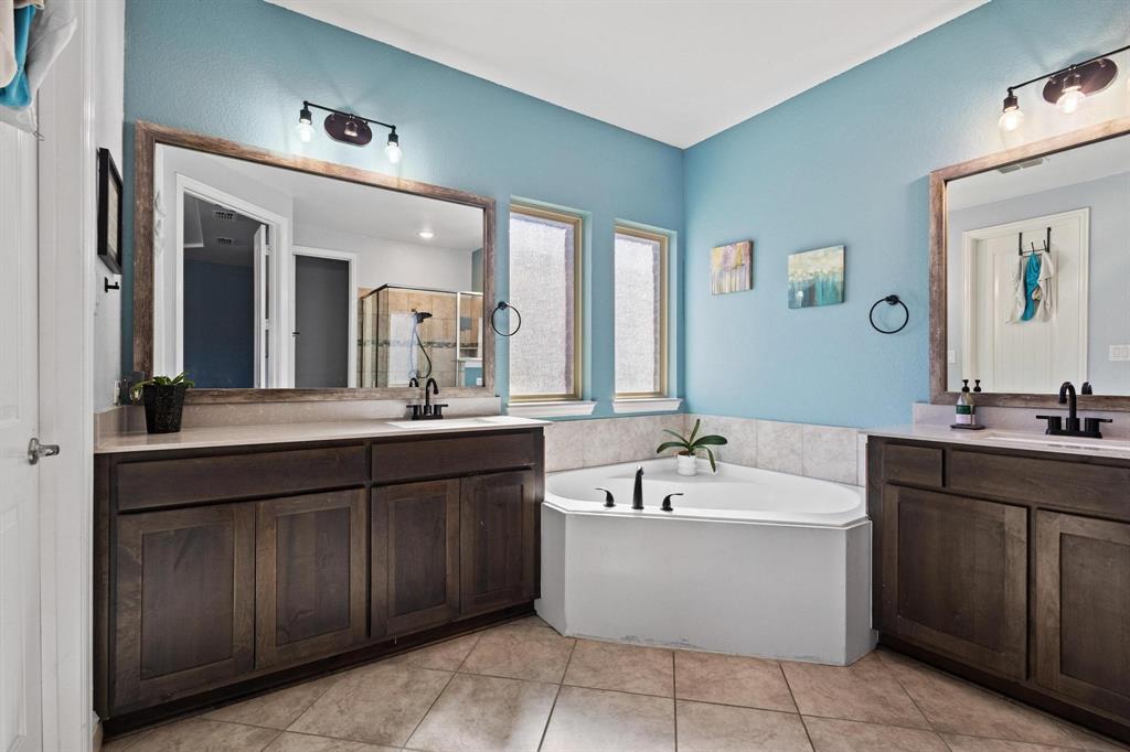 13798 Fernando Road Frisco, TX 75035 - Photo 19 of 39 a bathroom with a tub a double vanity sink a vanity and a large mirror