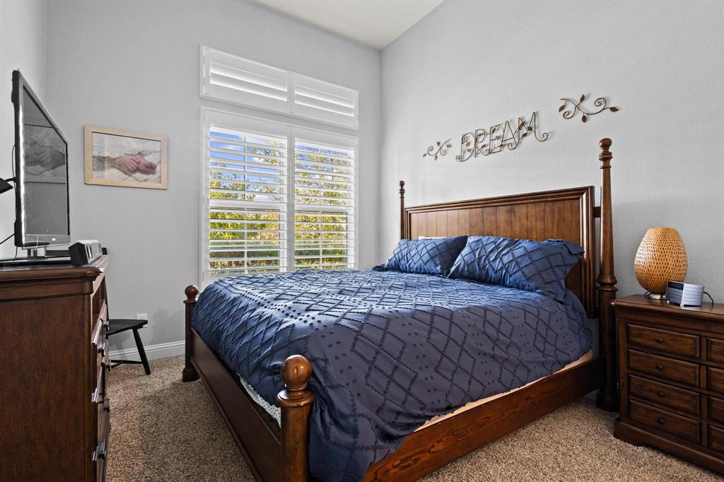 13798 Fernando Road Frisco, TX 75035 - Photo 21 of 39 a bed sitting in a bedroom next to a window