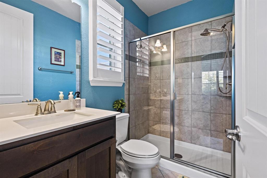 13798 Fernando Road Frisco, TX 75035 - Photo 22 of 39 a bathroom with a sink a toilet and shower